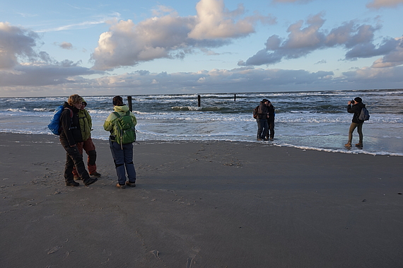 Photo: Students on the beach after work.